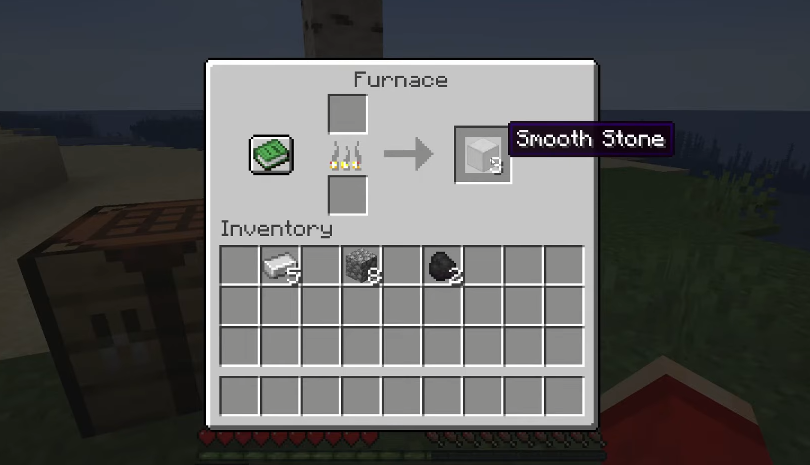 Three Smooth Stone ready to collect from a Minecraft Furnace